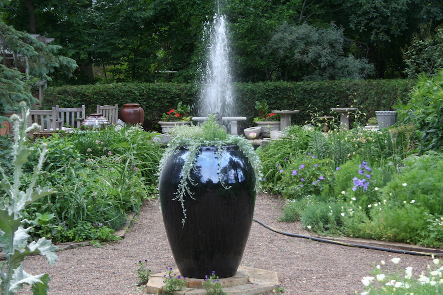black urn and fountain behind it