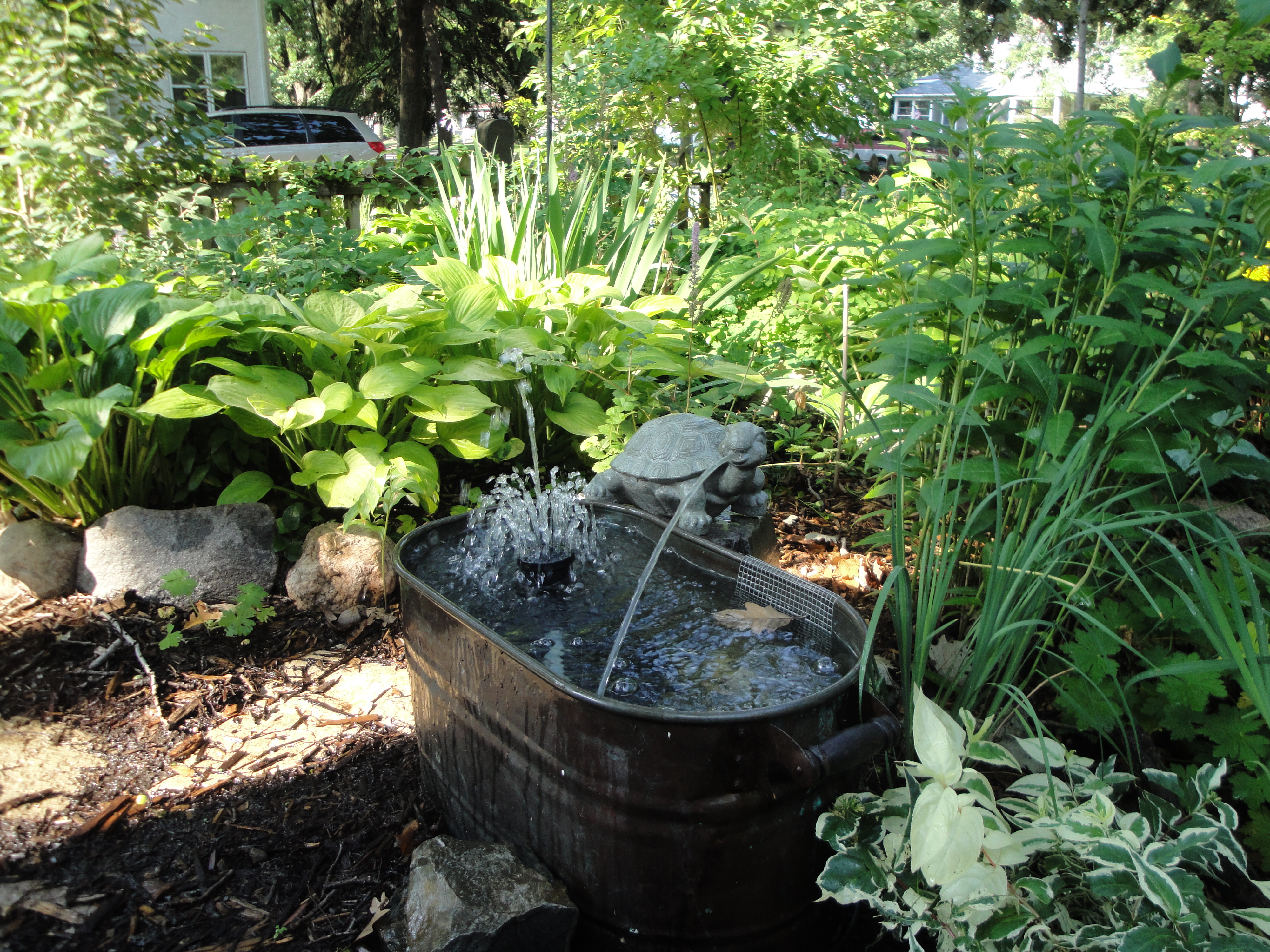 horse trough water fountain adds sound to the garden