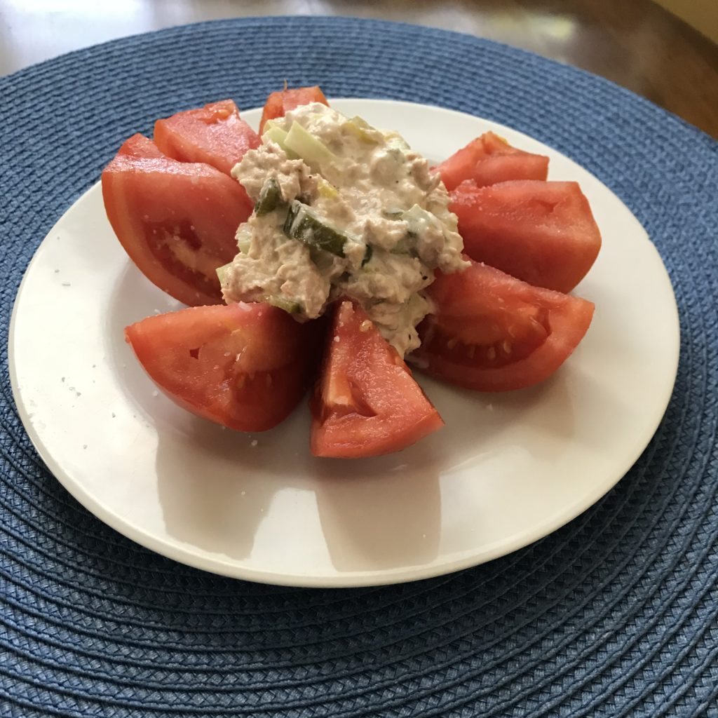 Tomato stuffed with tuna salad made with fermented pickles,